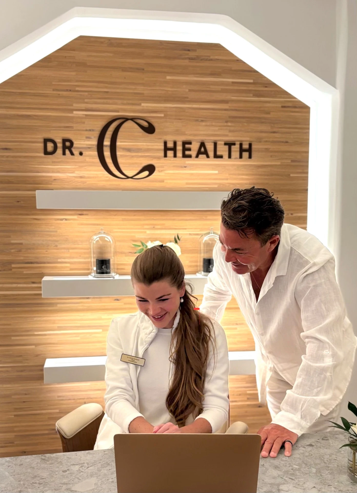 Dr. C Health team reviewing a consultation plan at the clinic desk